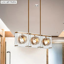 Postmodern gold and clear glass 3-light kitchen island light