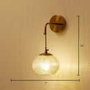 Postmodern gold ball shaped wall sconce with textured glass shade bedroom light