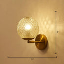 Postmodern gold ball shaped wall sconce with textured glass shade bedroom light