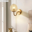 Postmodern gold ball shaped wall sconce with textured glass shade bedroom light
