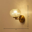 Postmodern gold ball shaped wall sconce with textured glass shade bedroom light