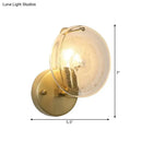 Postmodern gold metal wall sconce with clear glass shade bedroom light