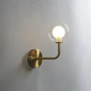 Retro brass curved wall lamp with clear glass ball for bedroom