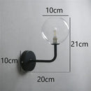 Retro brass curved wall lamp with clear glass ball for bedroom