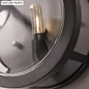 Retro dark gray metal wall sconce with clear glass shade living room
