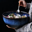 Rustic deep blue ceramic salad bowl with wooden fork dining room