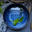 Rustic deep blue ceramic salad bowl with wooden fork dining room