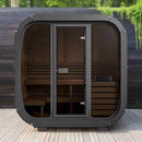 Portable sauna with wooden interior and glass doors on a wooden deck.