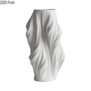 Sculpted white ceramic vase set with purple flowers for bedroom decor