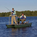 Two people fishing from a small boat on a calm lake with trees in the background.