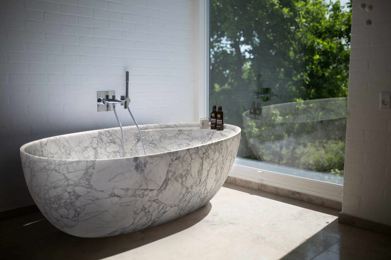 Statuario White Marble Bathtub Hand-carved from Solid Marble Block (W)32" (L)68" (H)20" installed modern bathroom next to huge window wide view