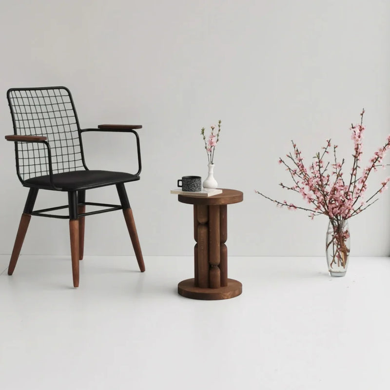 Stoa Designer Side Table Solid Wood Beech (W)10.5" (L)10.5" (H)16.5" next to black leather chair and flower inside glass vase book and cup on top the side table