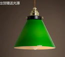 Teal blue glass pendant light with brass hardware for dining room