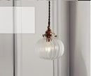 Teal blue glass pendant light with brass hardware for dining room