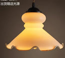 Teal blue glass pendant light with brass hardware for dining room