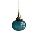 Teal glass ball pendant light with brass hardware for bedroom