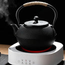 Textured black cast iron tea pot with infuser kitchen steeper