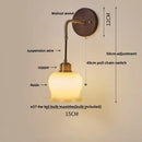 Textured glass and brass wall light fixture for dining room