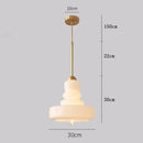 Tiered yellow glass pendant lights with brass accents for kitchens