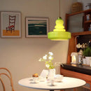 Tiered yellow glass pendant lights with brass accents for kitchens