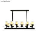 Traditional black cylinder dining room light with clear glass bulbs
