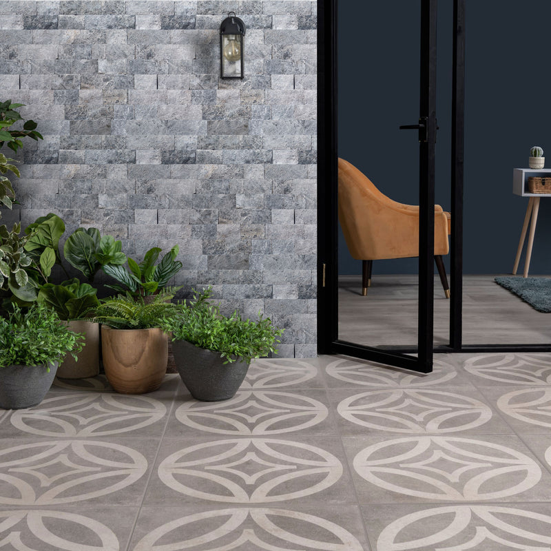 Tundra Gray 4"xFree Length Split-face Natural Marble Wall Tile - Belair Collection installed entrance of an office with plants in-front black doors