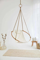 twill natural hanging round chair teak frame product shot vase wood side table throw blanket angle view