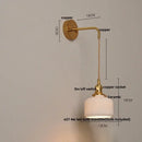 Vintage brass wall light with ribbed glass and knob switch bedroom
