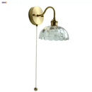 Vintage brass wall sconce with scalloped clear glass for stairways