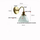 Vintage brass wall sconce with scalloped clear glass for stairways