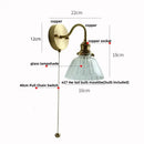 Vintage brass wall sconce with scalloped clear glass for stairways