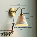 Vintage brass wall sconce with scalloped clear glass for stairways