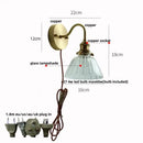 Vintage brass wall sconce with scalloped clear glass for stairways