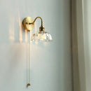 Vintage brass wall sconce with scalloped clear glass for stairways