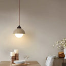 Warm textured concrete cave stone pendant light dining room