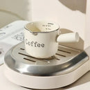White ceramic espresso measuring cup and milk pitcher kitchen decor