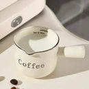 White ceramic espresso measuring cup and milk pitcher kitchen decor