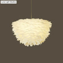 White floral pendant chandelier with feather accents for dining room