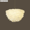 White floral pendant chandelier with feather accents for dining room