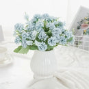 White hydrangea bouquet in ribbed glass vase for living room decor