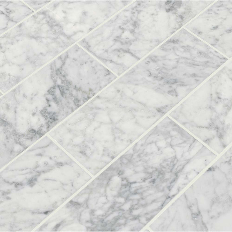 Arabescato carrara 4 x 12 honed marble floor and wall tile TARACAR412H product shot multiple tiles angle view