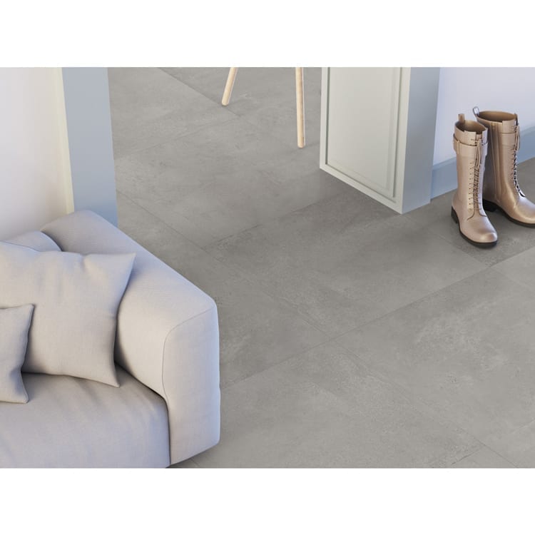 Bella Via Porcelain Tile Concrete Gris 12x24 Floor With Woman Boot And Beige Sofa