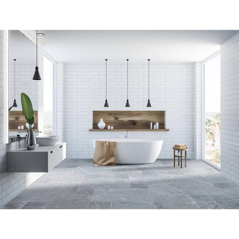 Bluestone marble outdoor tile pattern brushed sand blasted 40040106 installed on modern bathroom floor with white walls and a bathtub