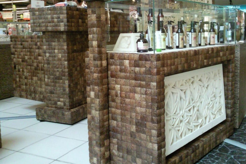 Coconut shell 2x2 Mesh-mounted Mosaic Wall Tile 911001 installed siding of product showcase in shopping mall