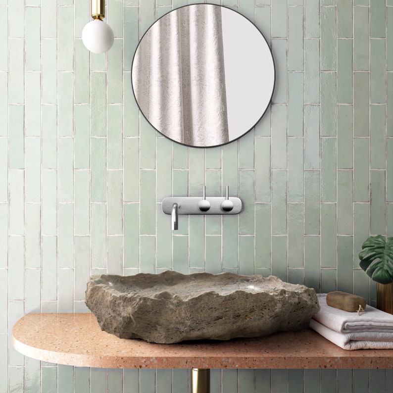 Silver Travertine Rustic Natural Stone Above Vanity Random Shape Sink installed bathroom green wall tiles on the all and white towels on orange vanity