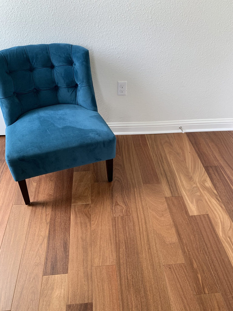 Solid Hardwood Floors Brazilian Teak Cumaru Pre-finished 5 premium Collection SHWSAC237 installed on living room floor with blue chair