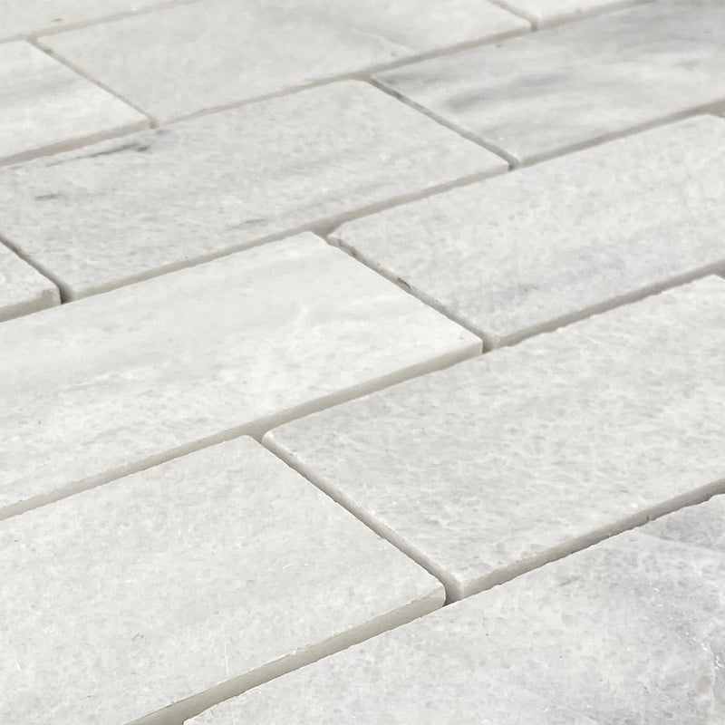 Solto white marble mosaic tile 2x4 brick on 12x12 mesh honed angle closeup view