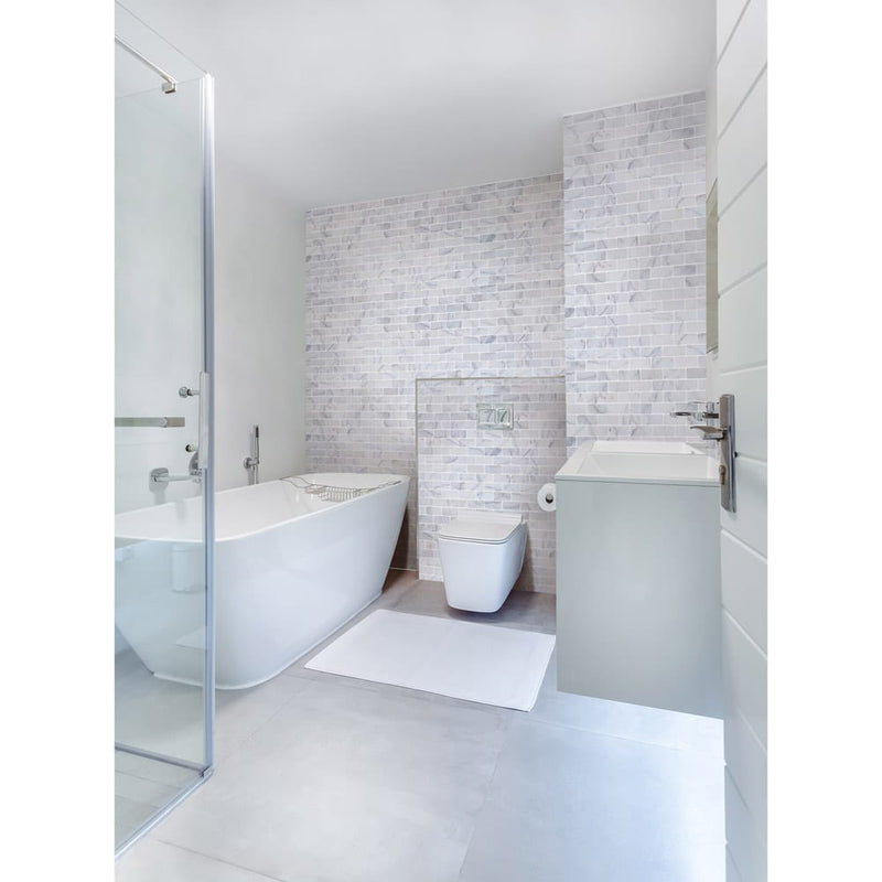 bianco ibiza white marble mosaic tile 2x4 backsplash tumbled BIBZWMM2x4T installed on bathroom wall