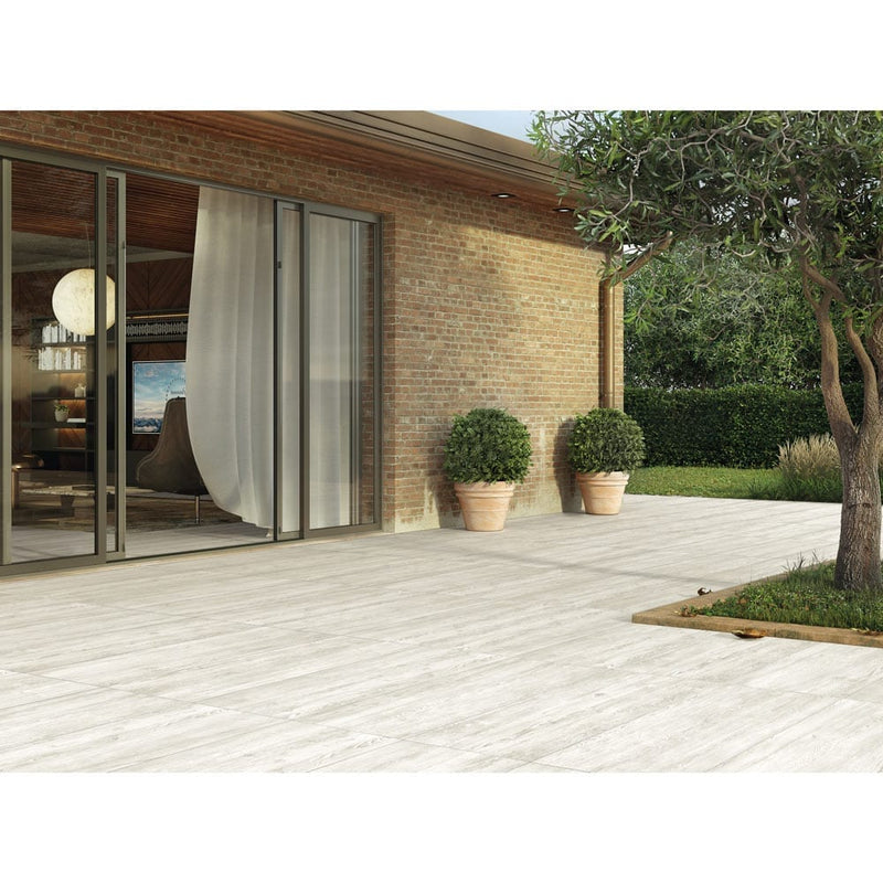 caldera blanca porcelain pavers 16x47in matte floor tile LPAVNCALBLA1647 installed on backyard of a house
