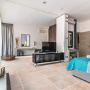 classic light beige travertine tile 24x24 Honed and Filled installed to a hotel room floor closeup